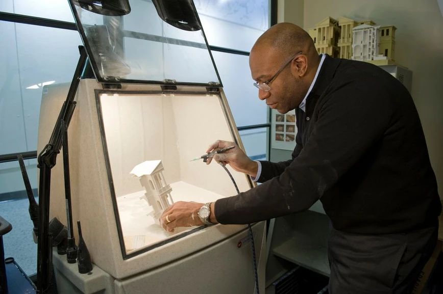 MIT: An MIT professor works on an architectural model.