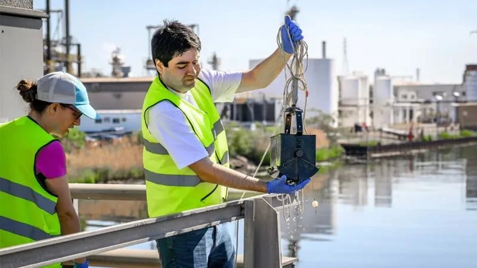 University of Notre Dame / Matt Cashore, Barbara Johnston: Graduate student Anthony Miller lifts a sample of the sediment at the bottom of the Lake George Canal, a section of the Grand Calumet River in East Chicago, Indiana.