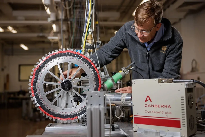 University of Notre Dame / Peter Ringenberg: Samples of different materials including textiles and paper products are affixed to a testing wheel. PIGE uses a proton beam to bombard the surface of any solid material, causing fluorine nuclei to emit gamma-rays which are then measured to detect the presence of PFAS.